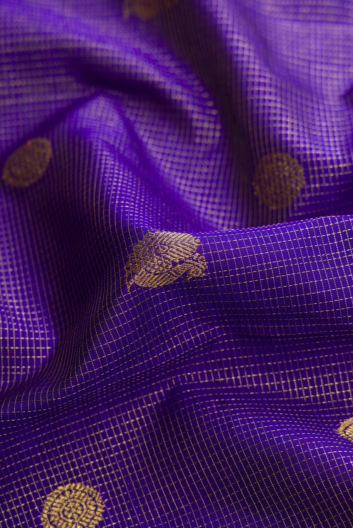 Close up of Royal Blue Dual Tone Kanchipuram Silk Saree with Checked design on the body and Zari Border.  displaying folds