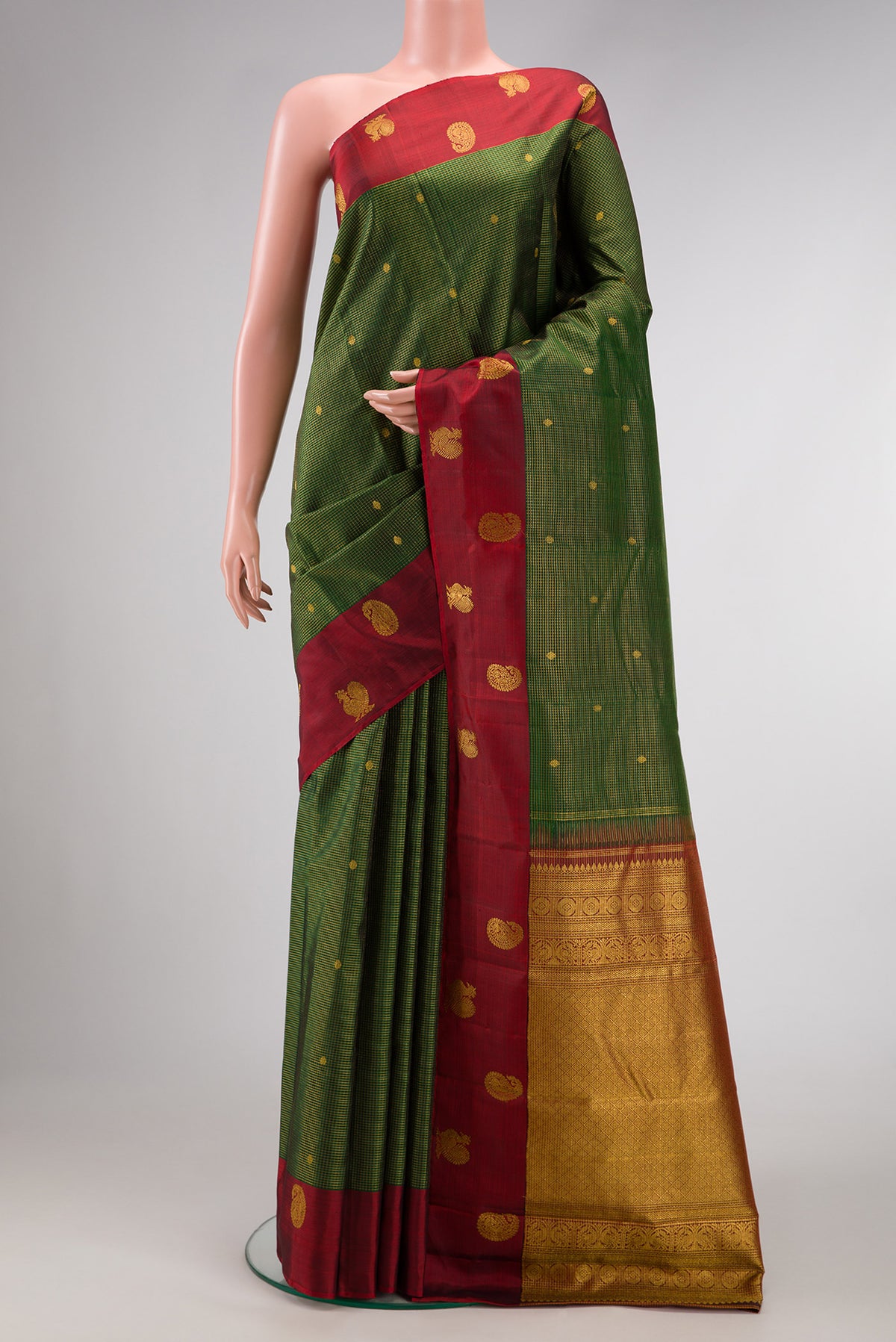 Bottle Green Dual Tone Kanjivaram Silk Saree with Checked design on the body and Fancy Border.  displayed on a mannequin