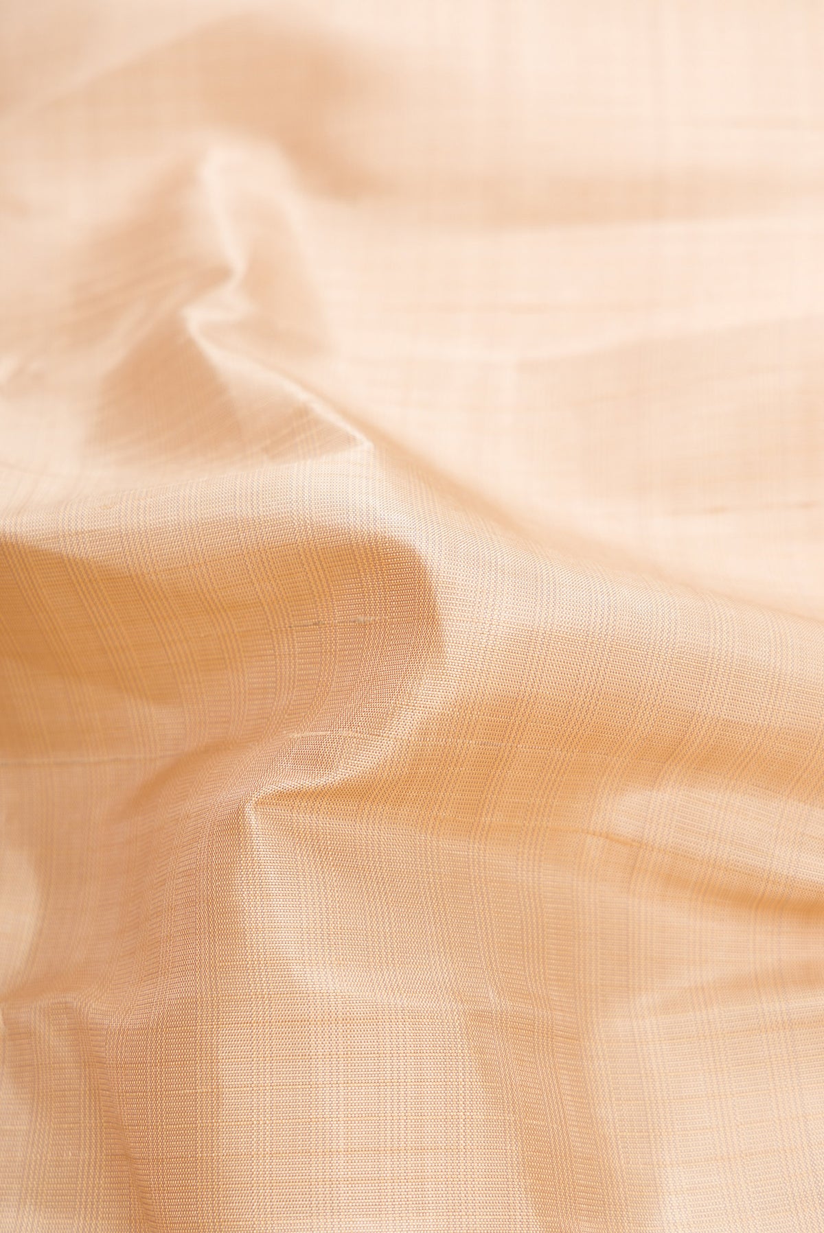 Close up of Beige Kanjivaram Silk Saree with Checked design on the body and Plain Border.  displaying folds
