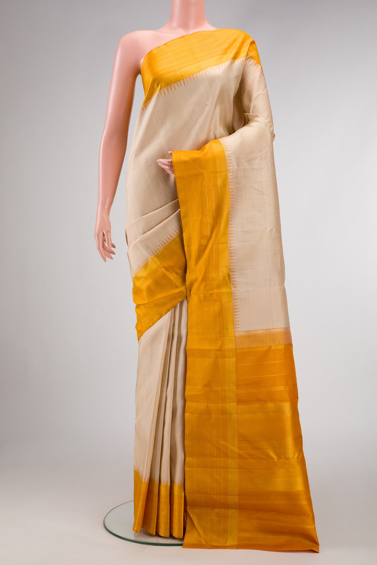 Beige Kanjivaram Silk Saree with Checked design on the body and Plain Border.  displayed on a mannequin