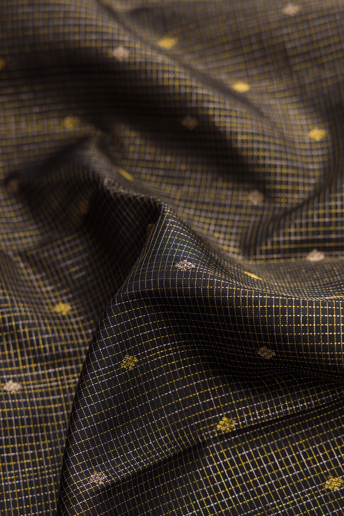 Close up of Black Kanjivaram Silk Saree with Checked design on the body and Fancy Border.  displaying folds