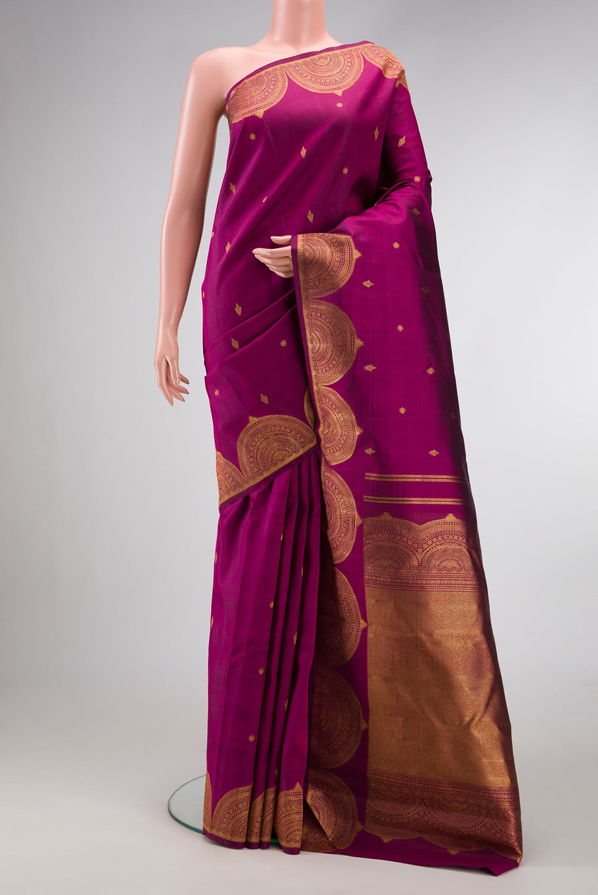 Magenta Kanjivaram Silk Saree with Zari Butta on the body and Fancy Border.  displayed on a mannequin