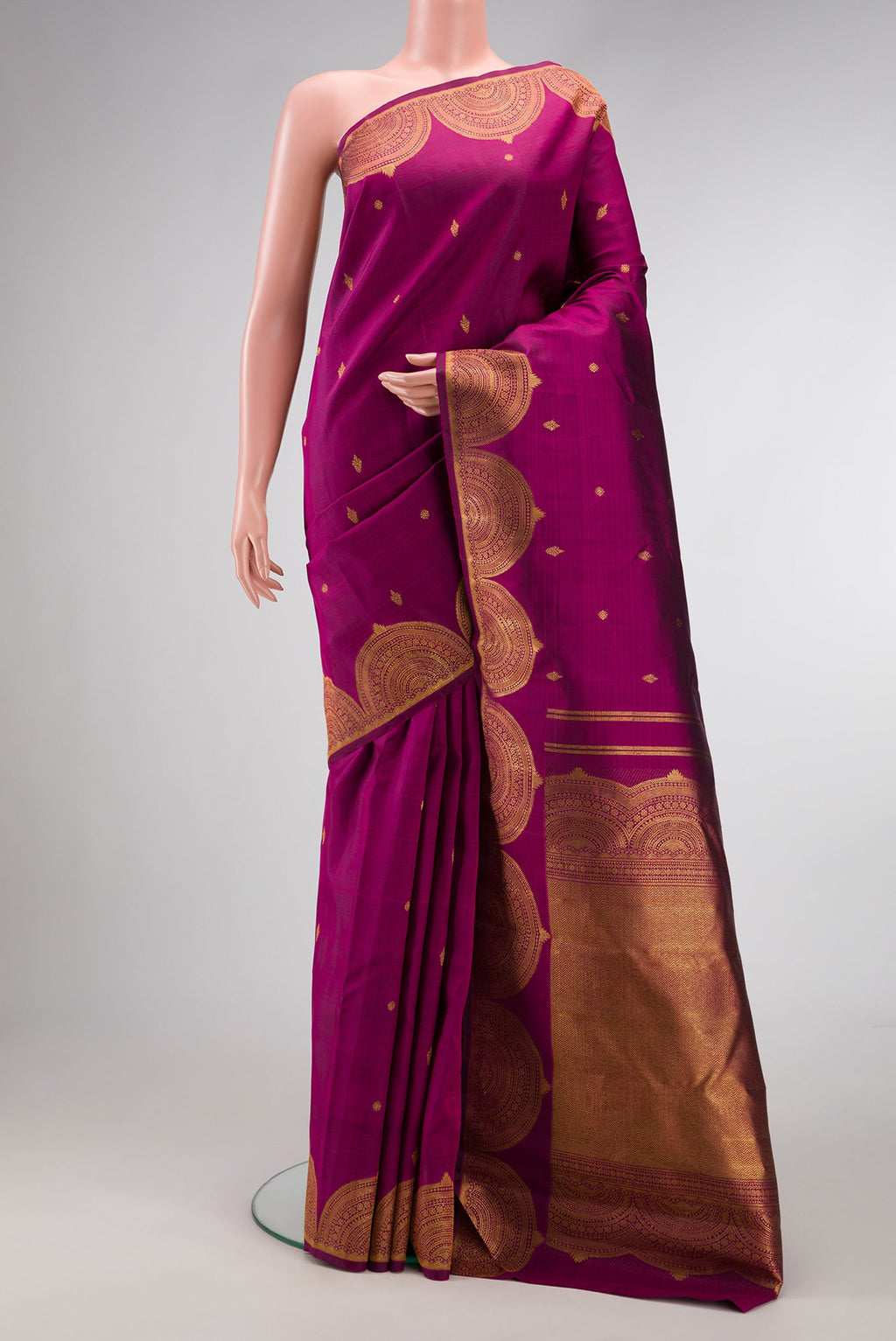 Magenta Dual Tone Kanjivaram Silk Saree with Zari Butta on the body and Fancy Border.  displayed on a mannequin