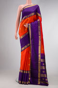 Orange Dual Tone Kanjivaram Silk Saree with Zari Butta on the body and Zari Border.  displayed on a mannequin