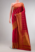 Maroon Kanjivaram Silk Saree with Zari Butta on the body and Fancy Border.  displayed on a mannequin
