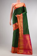 Bottle Green Kanchipuram Silk Saree with Checked design on the body and Zari Border.  displayed on a mannequin