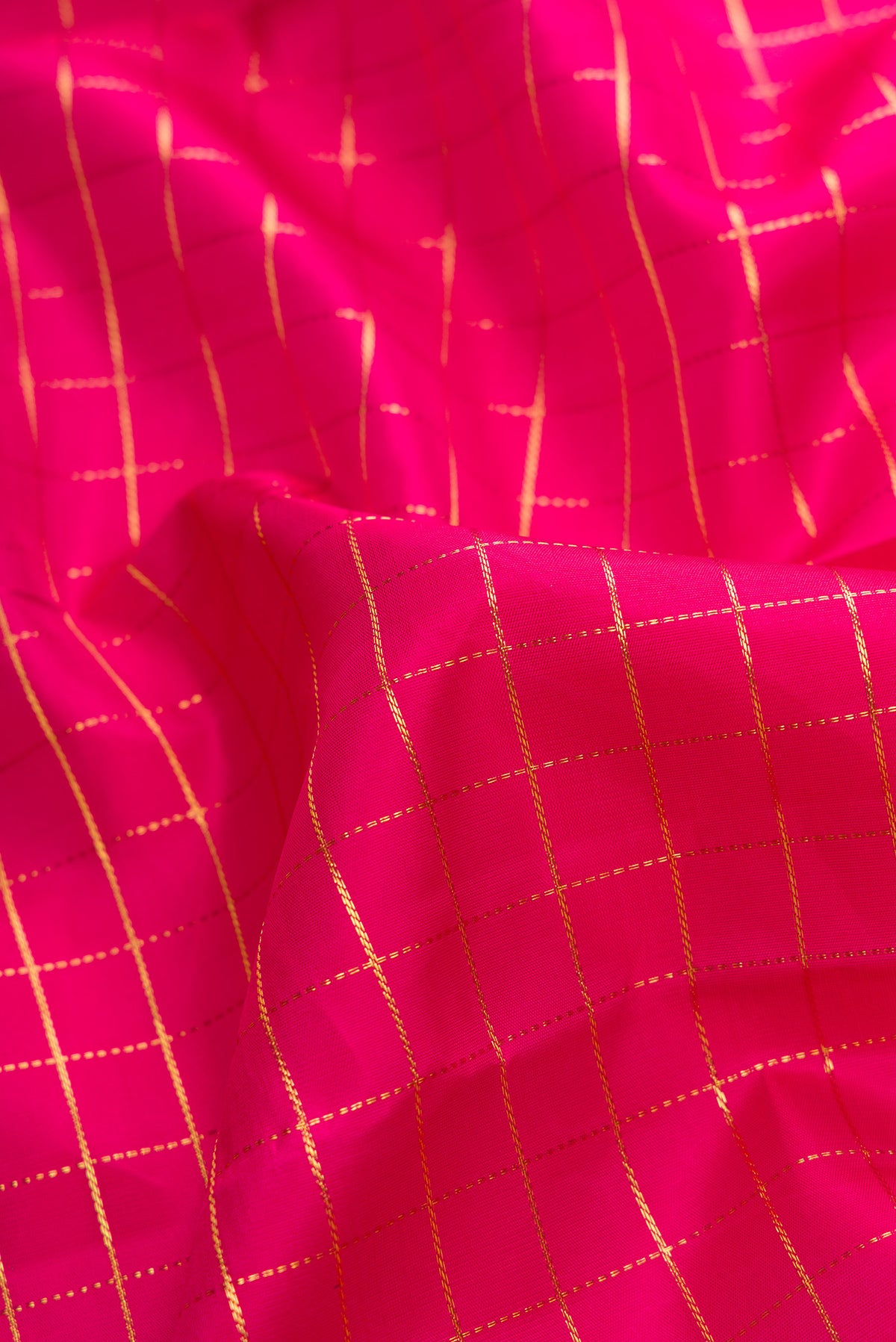 Close up of Pink Kanchipuram Silk Saree with Checked design on the body and Zari Border.  displaying folds