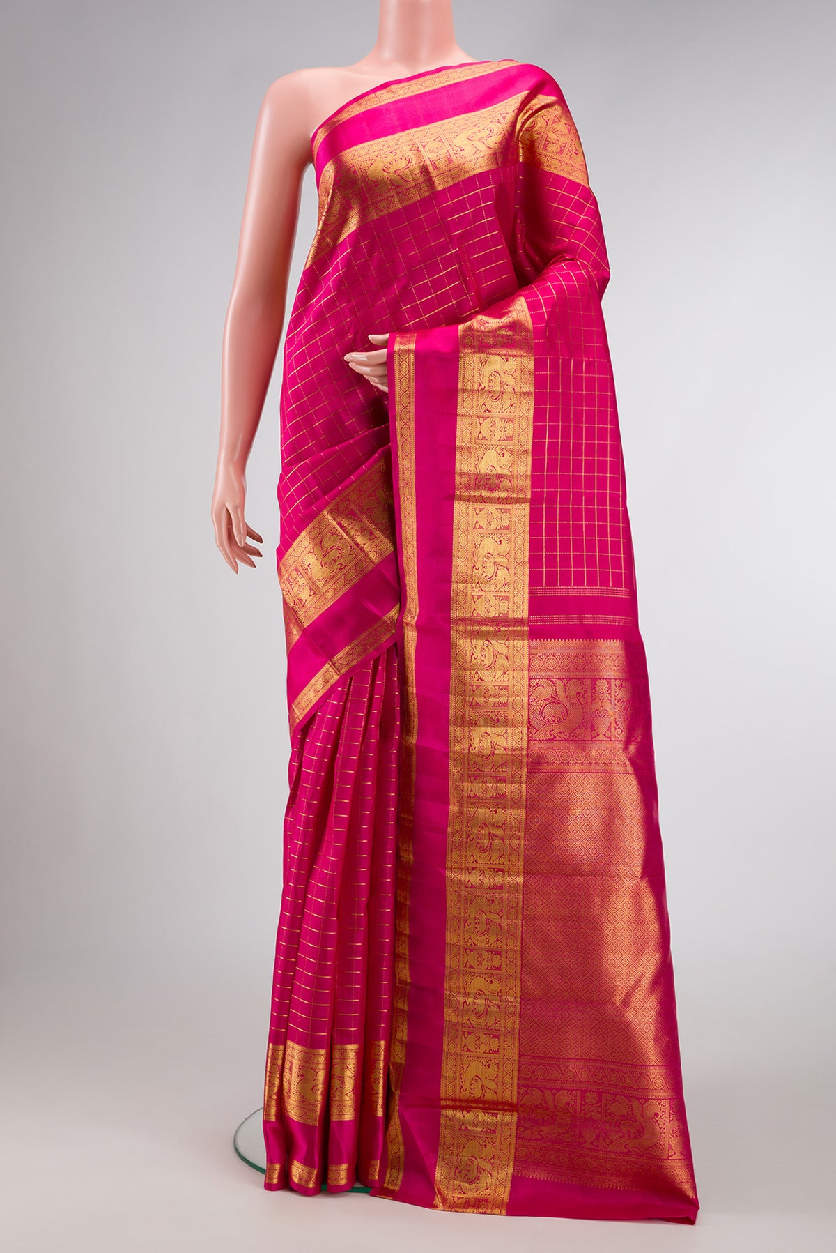 Pink Kanchipuram Silk Saree with Checked design on the body and Zari Border.  displayed on a mannequin