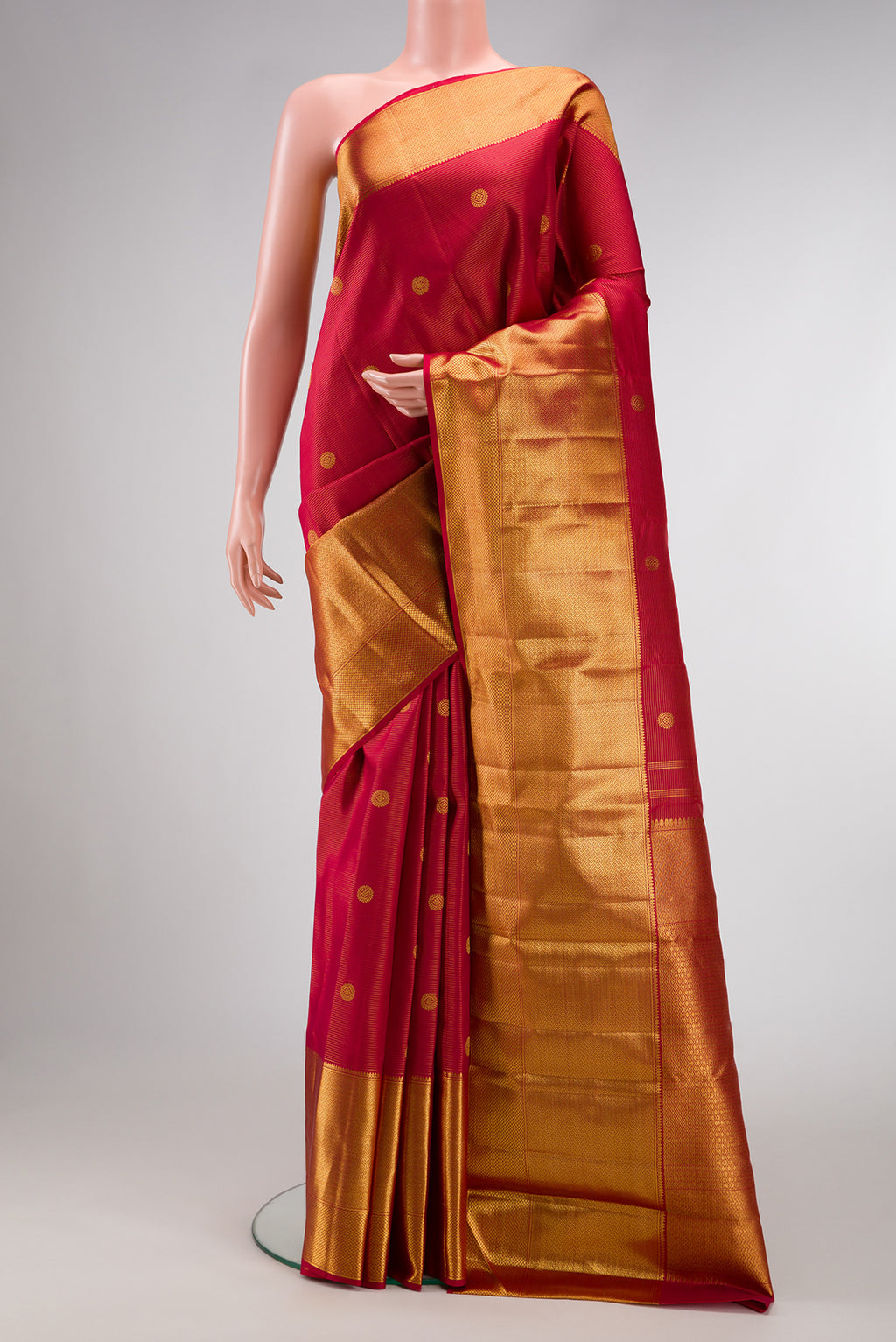 Red Kanchipuram Silk Saree with Zari Butta on the body and Zari Border.  displayed on a mannequin