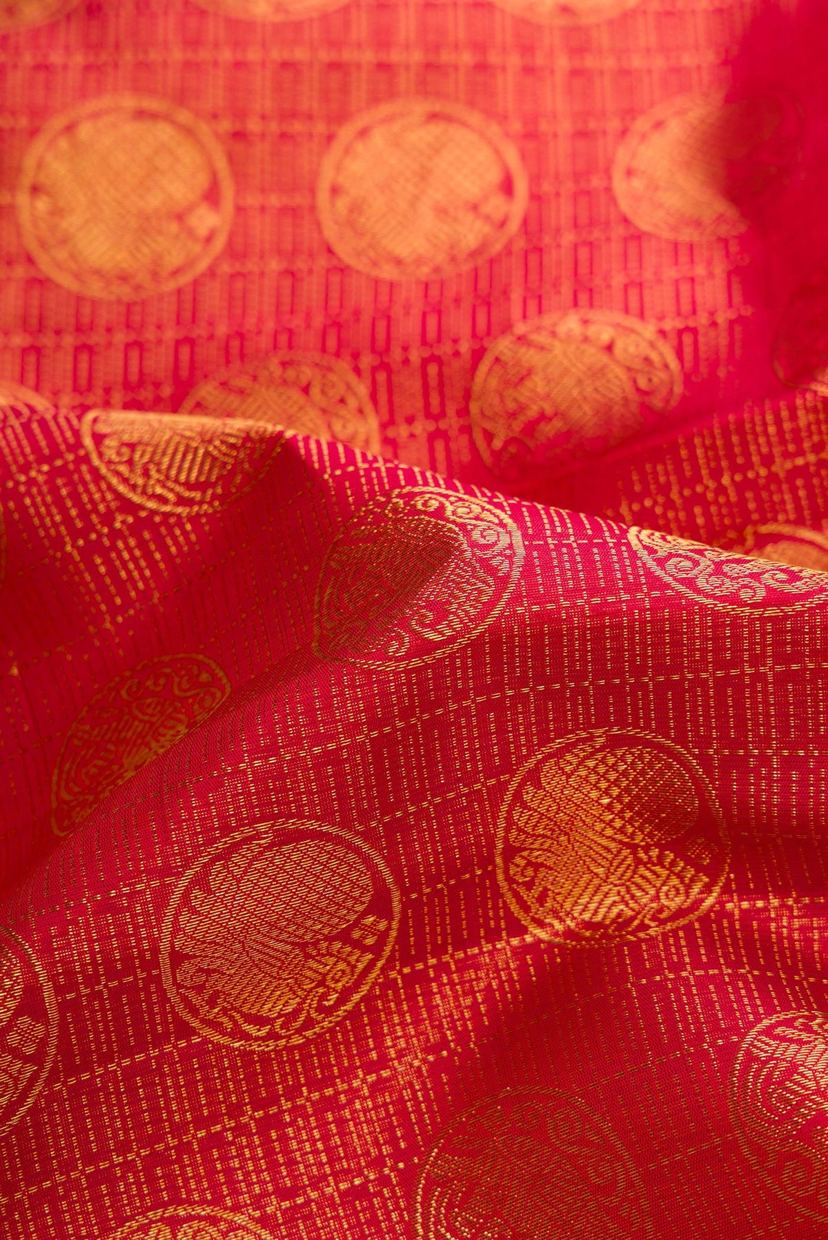 Close up of Maroon Dual Tone Kanchipuram Silk Saree with Zari Brocade on the body and Zari Border.  displaying folds