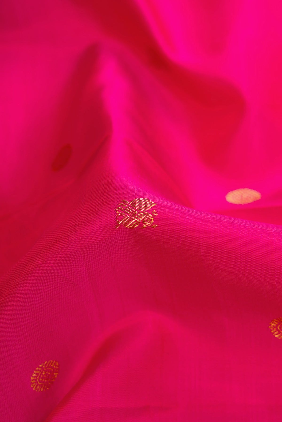 Close up of Pink Dual Tone Kanchipuram Silk Saree with Zari Butta on the body and Zari Border.  displaying folds