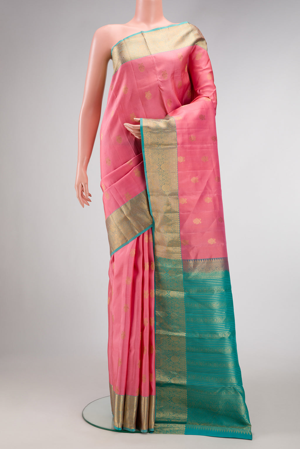 Pink Kanchipuram Silk Saree with Zari Butta on the body and Zari Border.  displayed on a mannequin