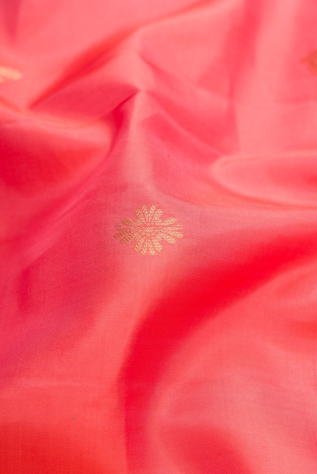 Close up of Pink Dual Tone Kanchipuram Silk Saree with Zari Butta on the body and Zari Border.  displaying folds
