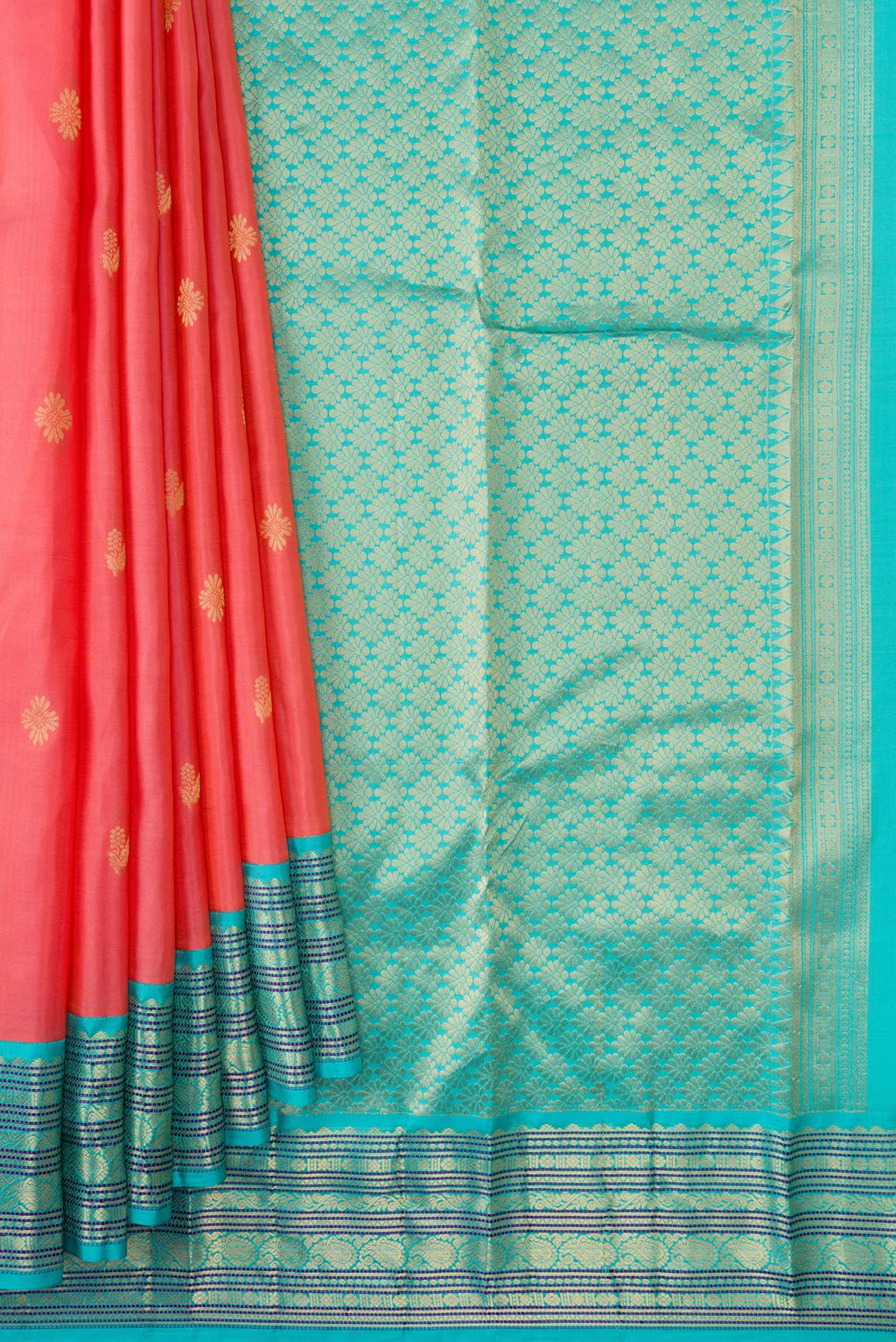 Pleats and pallu of Coral Kanchipuram Silk Saree with Zari Butta on the body and Zari Border. 
