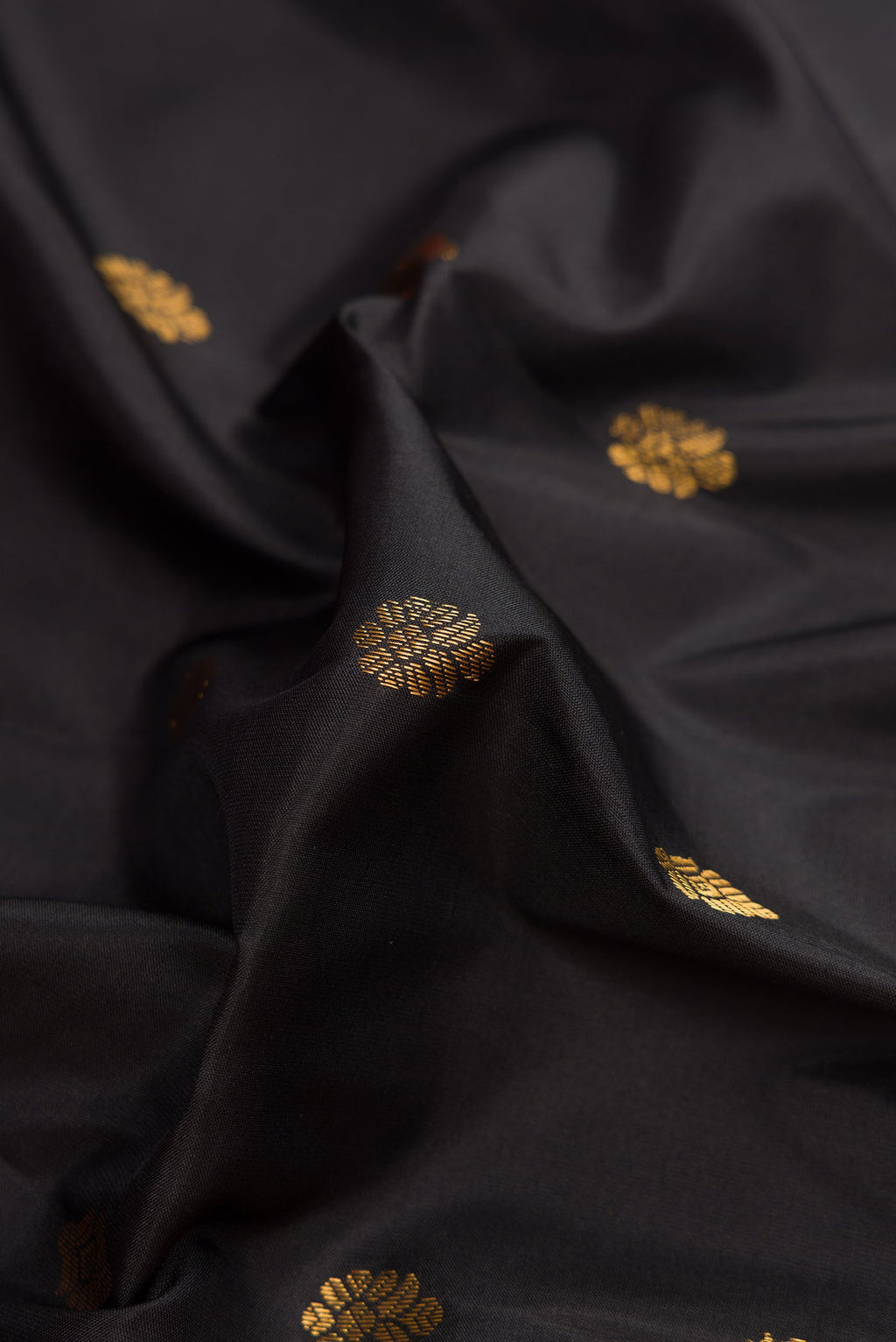 Close up of Black Dual Tone Gadwal Silk Saree with Zari Butta on the body and Zari Border.  displaying folds