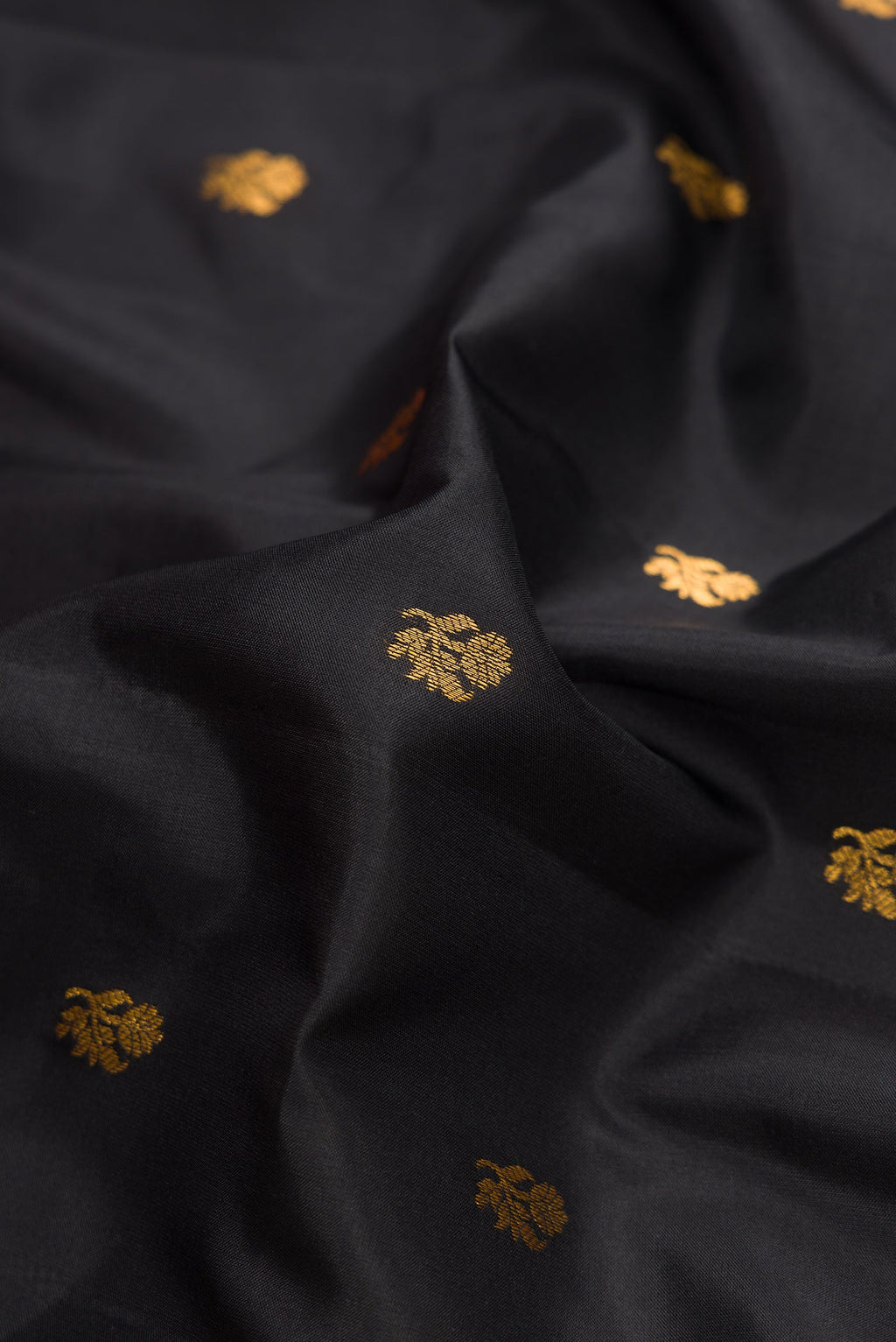 Close up of Black Dual Tone Gadwal Silk Saree with Zari Butta on the body and Zari Border.  displaying folds