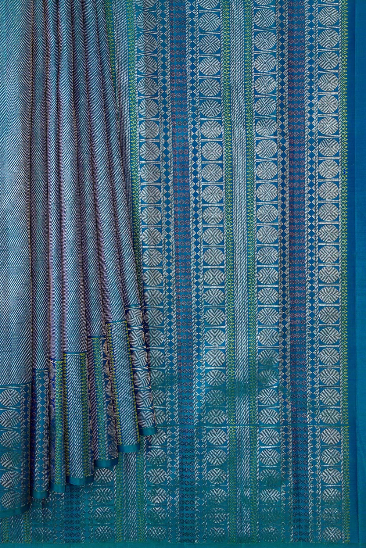 Pleats and pallu of Peacock Blue Dual Tone Kanchipuram Silk Saree with Zari Brocade on the body and Fancy Border. 