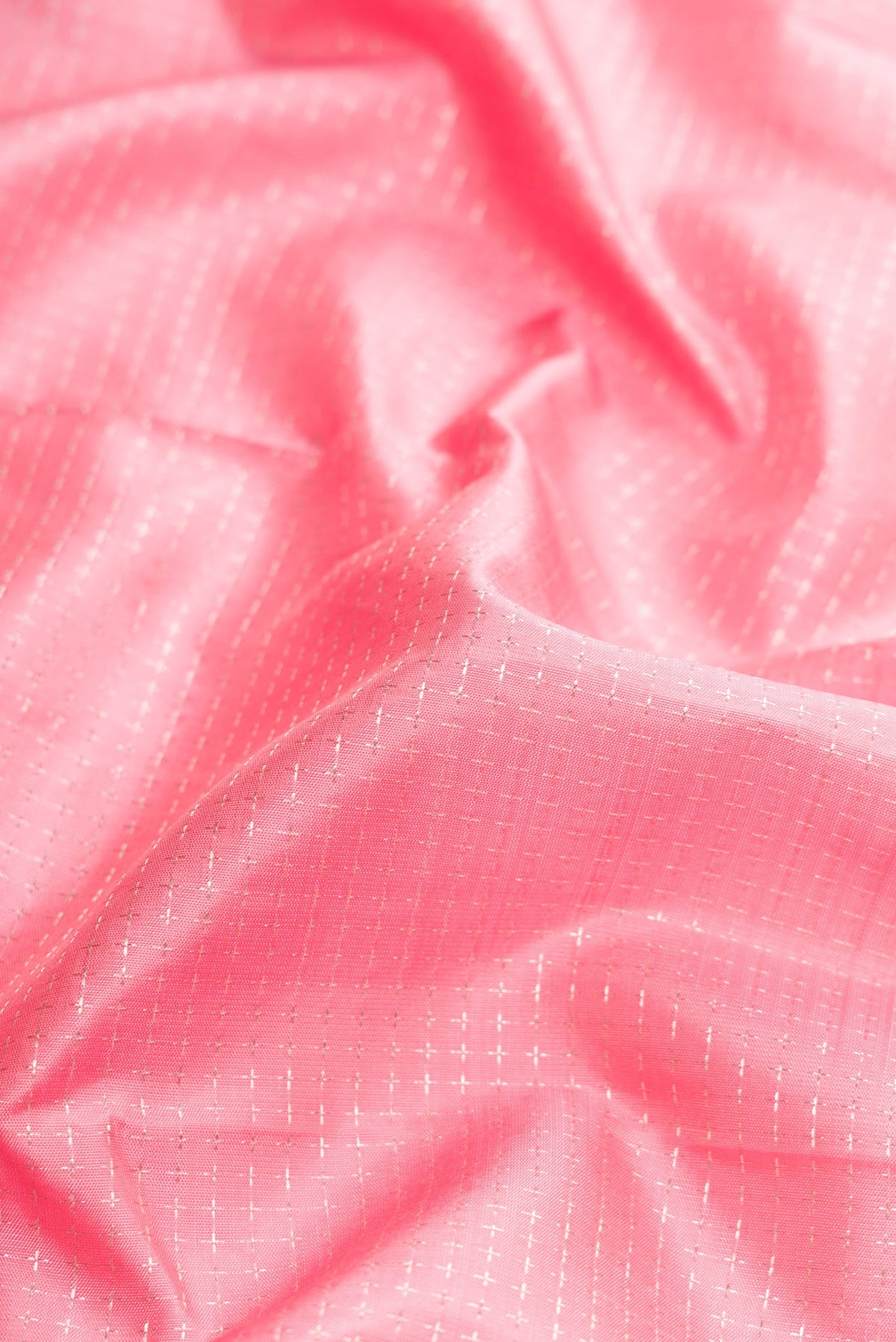 Close up of Pink Dual Tone Kanjivaram Silk Saree with Zari Butta on the body and Zari Border.  displaying folds