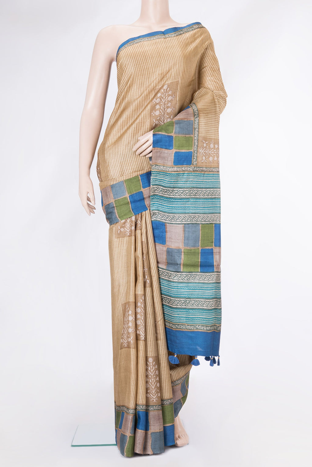 Beige Tussar Silk Saree with Printed design on the body and Printed Border.  displayed on a mannequin