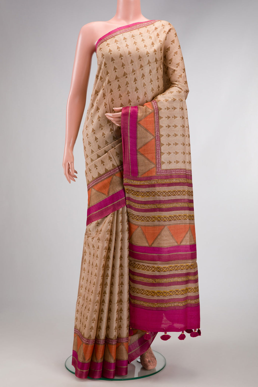 Beige Dual Tone Tussar Silk Saree with Printed design on the body and Fancy Border.  displayed on a mannequin