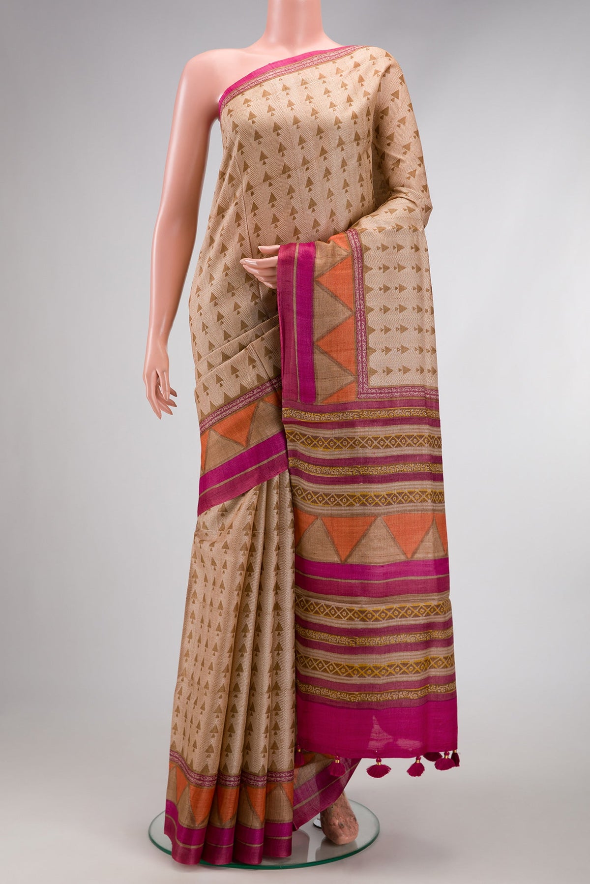 Beige Dual Tone Tussar Silk Saree with Printed design on the body and Fancy Border.  displayed on a mannequin