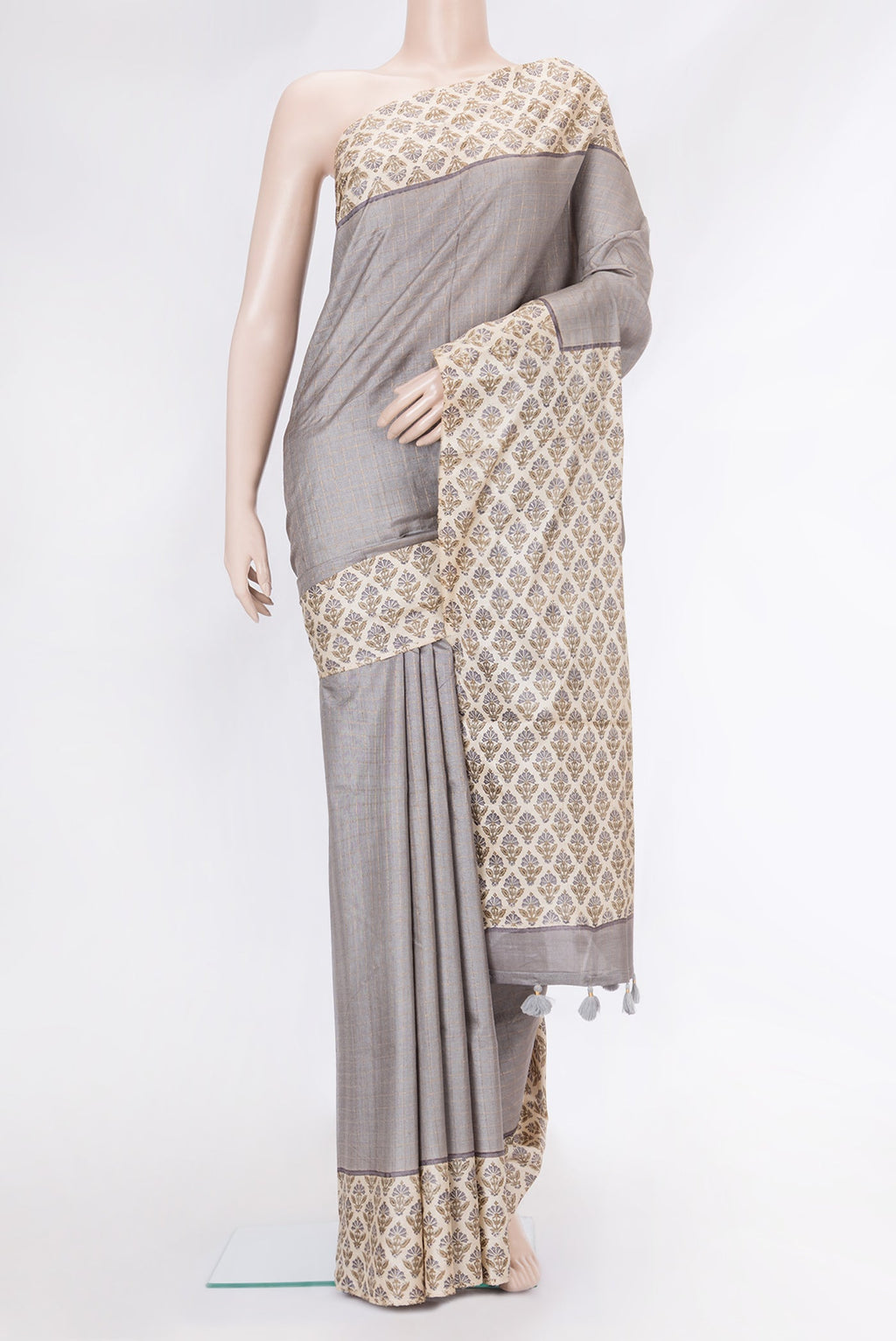 Grey Dual Tone Tussar Silk Saree with Checked design on the body and Printed Border.  displayed on a mannequin