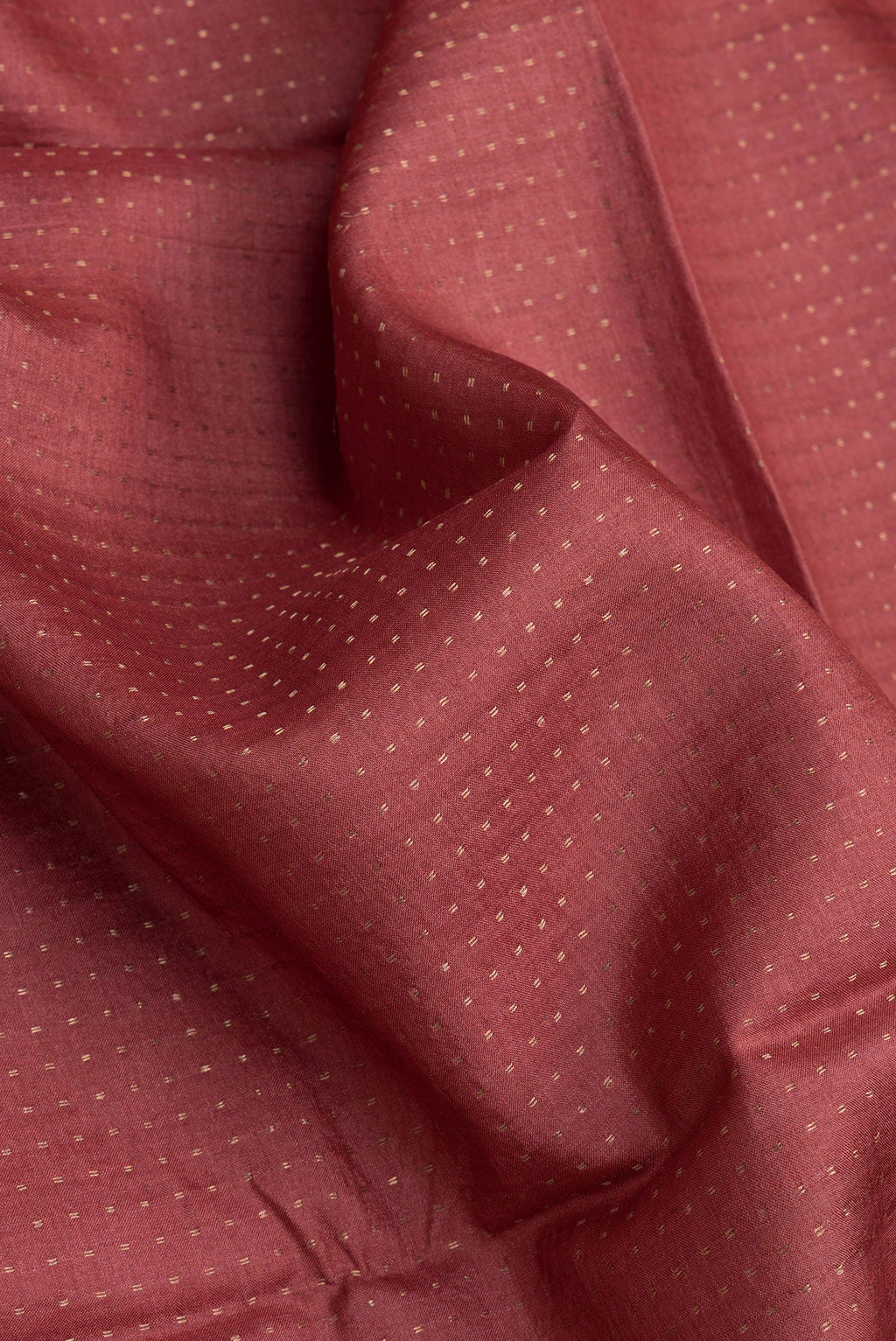 Close up of Maroon Dual Tone Tussar Silk Saree with Stripes on the body and Printed Border.  displaying folds