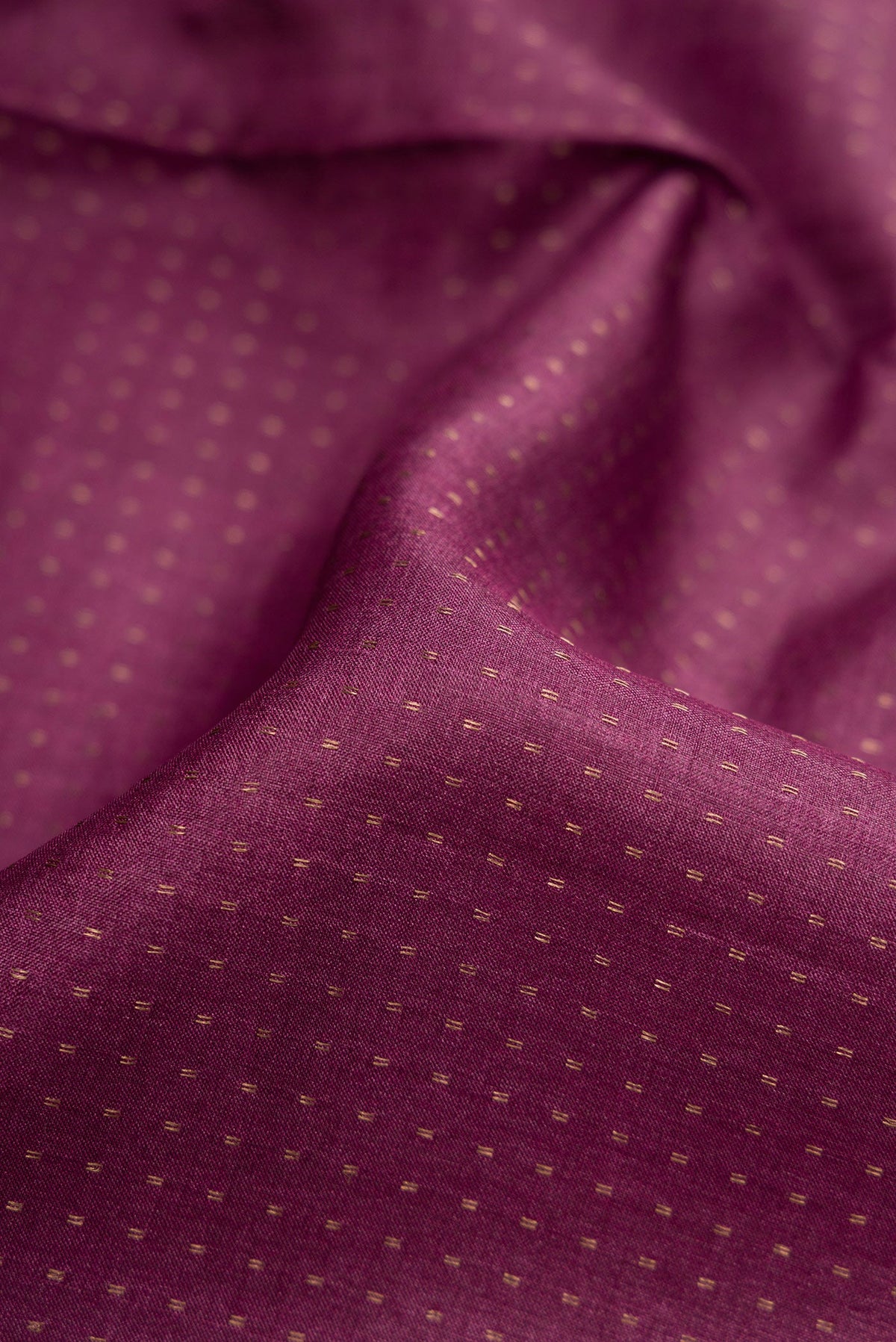 Close up of Magenta Dual Tone Tussar Silk Saree with Stripes on the body and Printed Border.  displaying folds