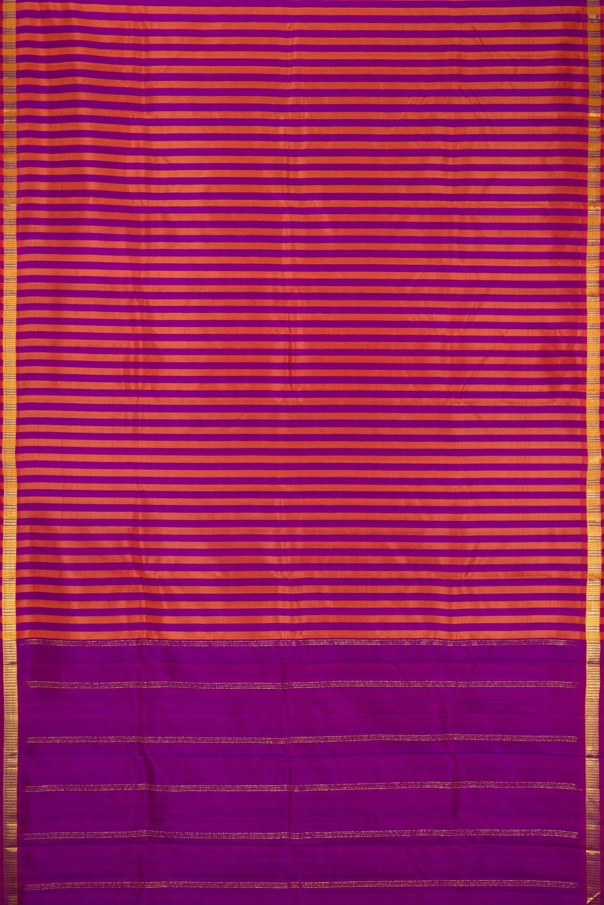 Purple and Brick Orange Color Kanchipuram Silk Saree with Stripes on the body and Zari Border.  displayed on a mannequin