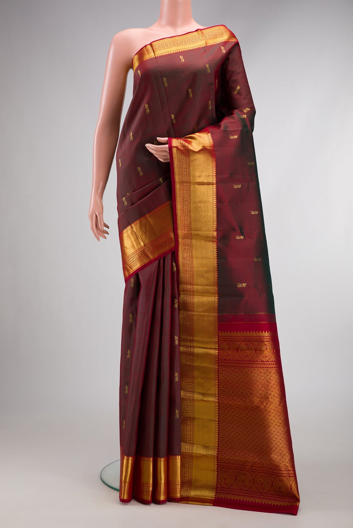 Maroon Dual Tone Kanjivaram Silk Saree with Zari Butta on the body and Zari Border.  displayed on a mannequin
