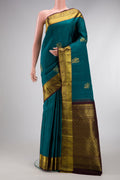 Teal Dual Tone Kanjivaram Silk Saree with Zari Butta on the body and Zari Border.  displayed on a mannequin