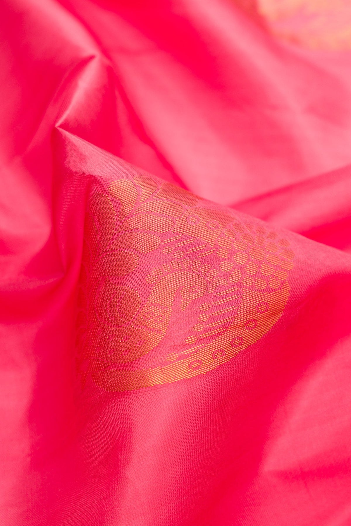 Close up of Pink Dual Tone Soft Silk Saree with Zari Butta on the body and Zari Border.  displaying folds