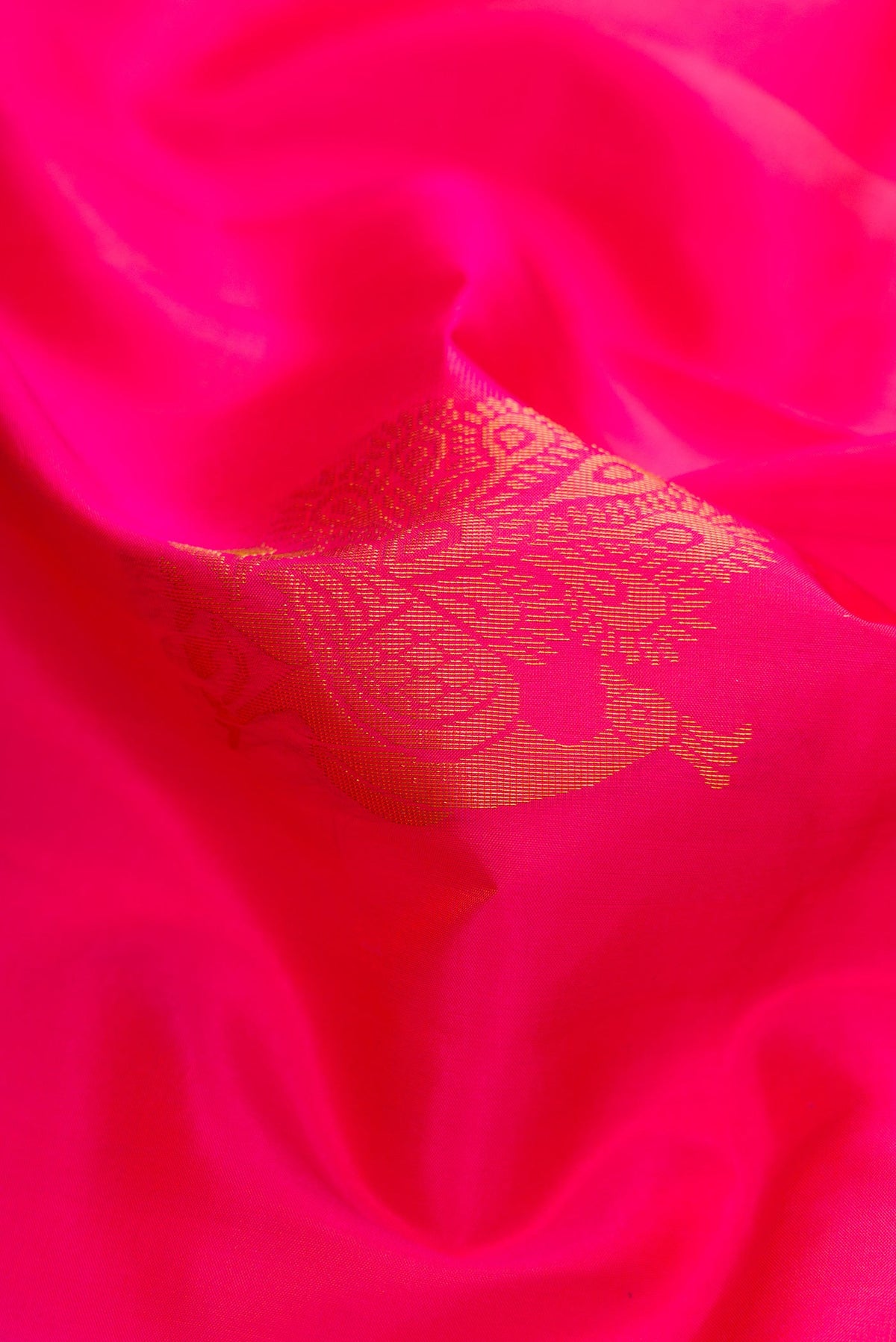 Close up of Pink Soft Silk Saree with Zari Butta on the body and Zari Border.  displaying folds