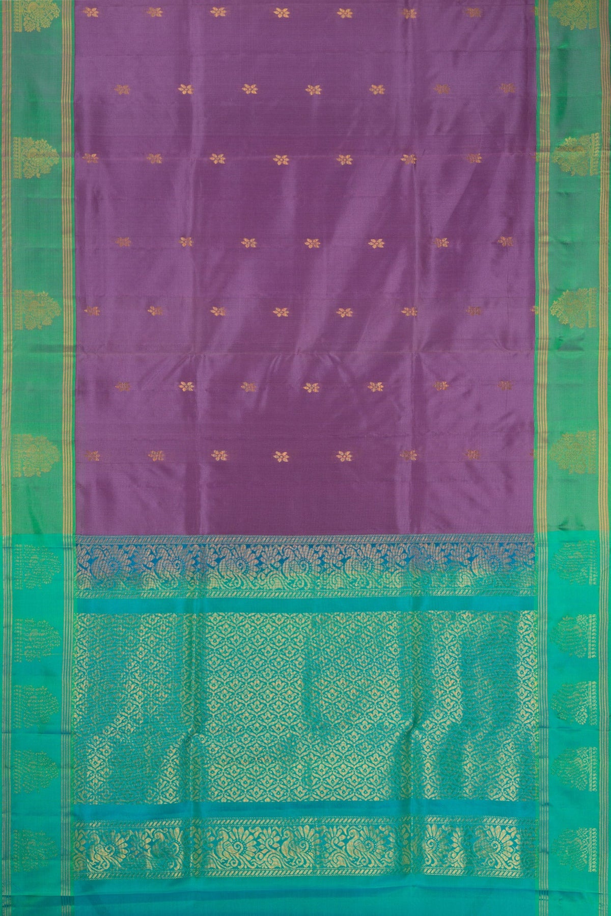 Flat view of Lavender Soft Silk Saree with Zari Butta on the body and Fancy Border. 