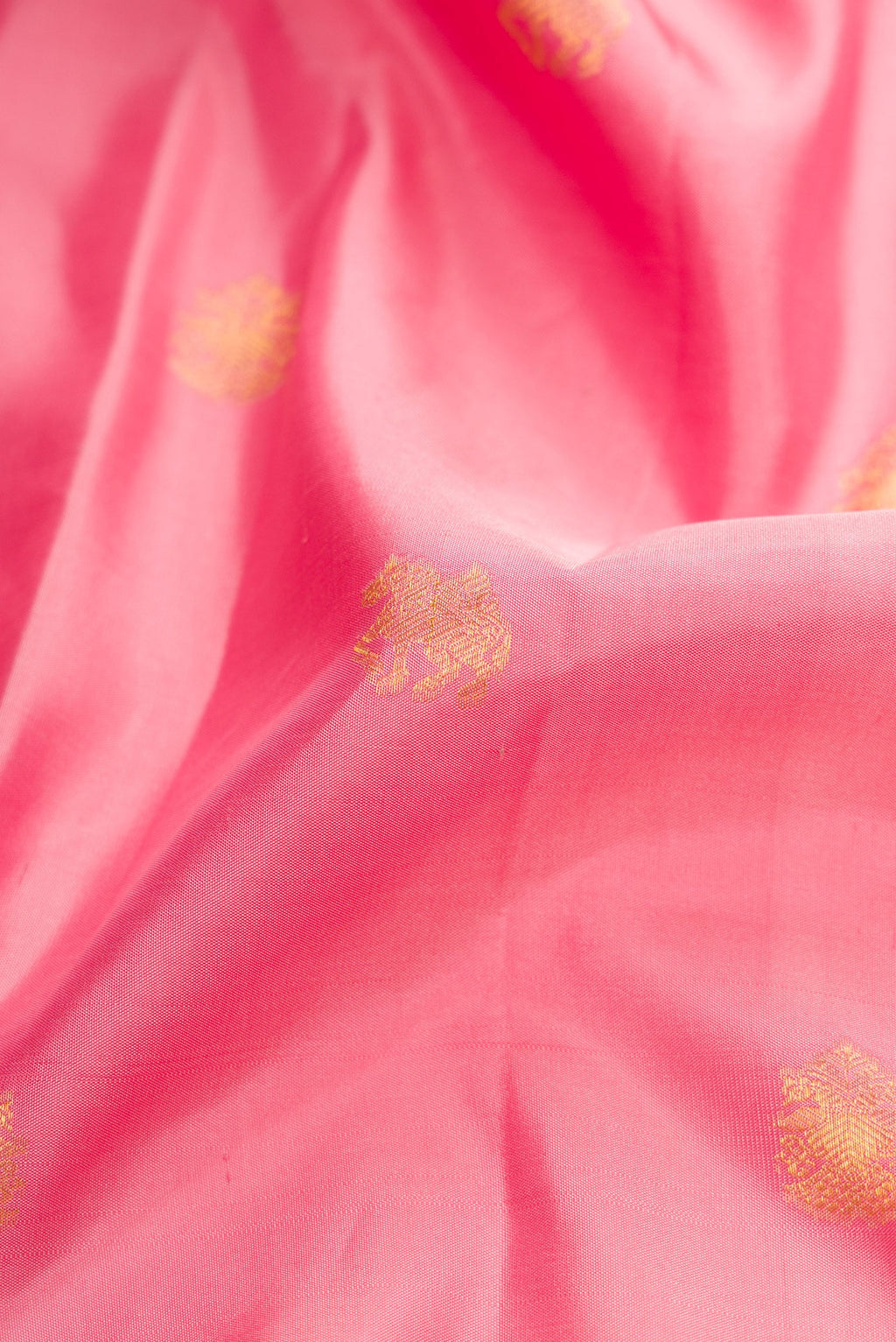 Close up of Pink Dual Tone Kanchipuram Silk Saree with Zari Butta on the body and Zari Border.  displaying folds
