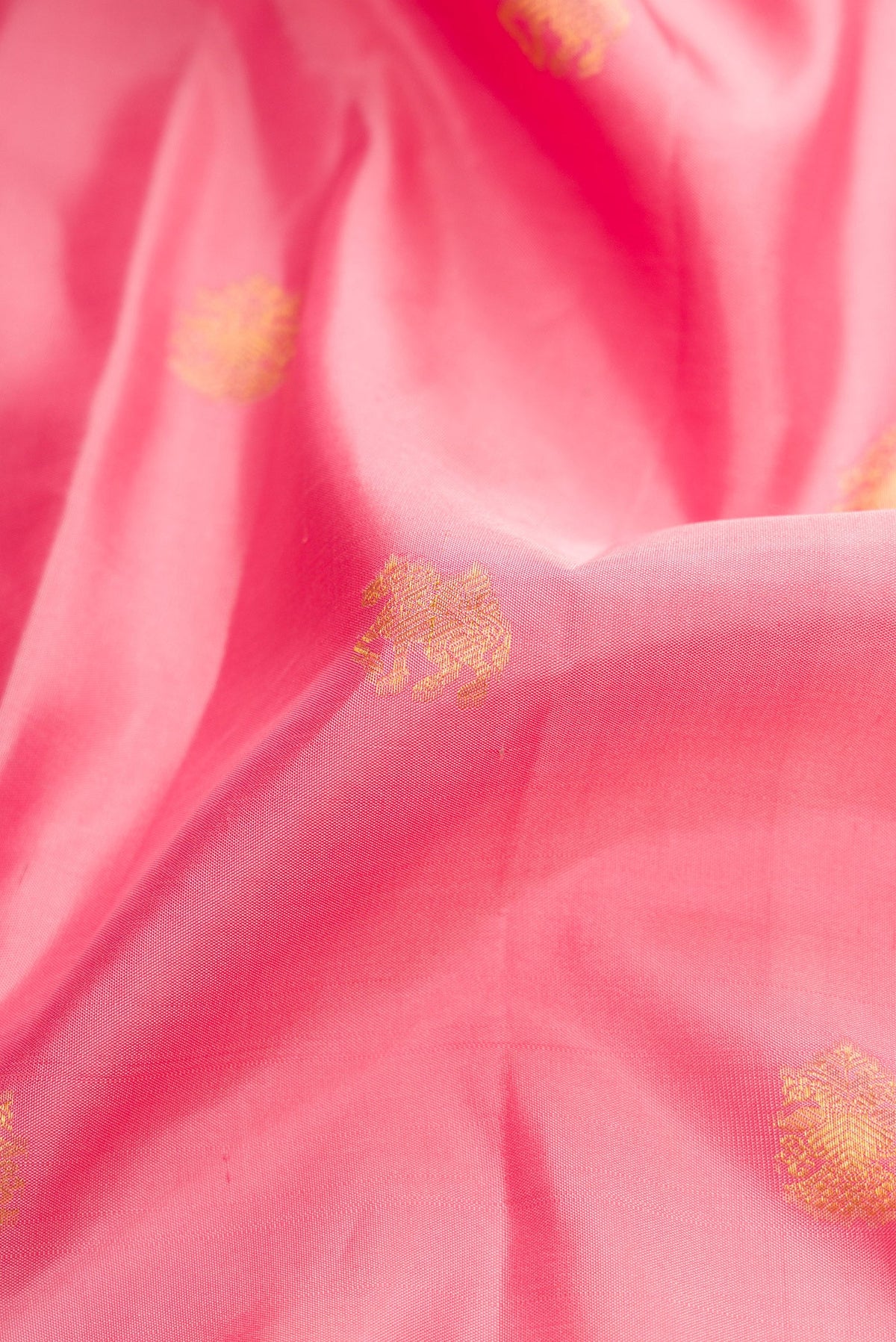 Close up of Pink Dual Tone Kanchipuram Silk Saree with Zari Butta on the body and Zari Border.  displaying folds