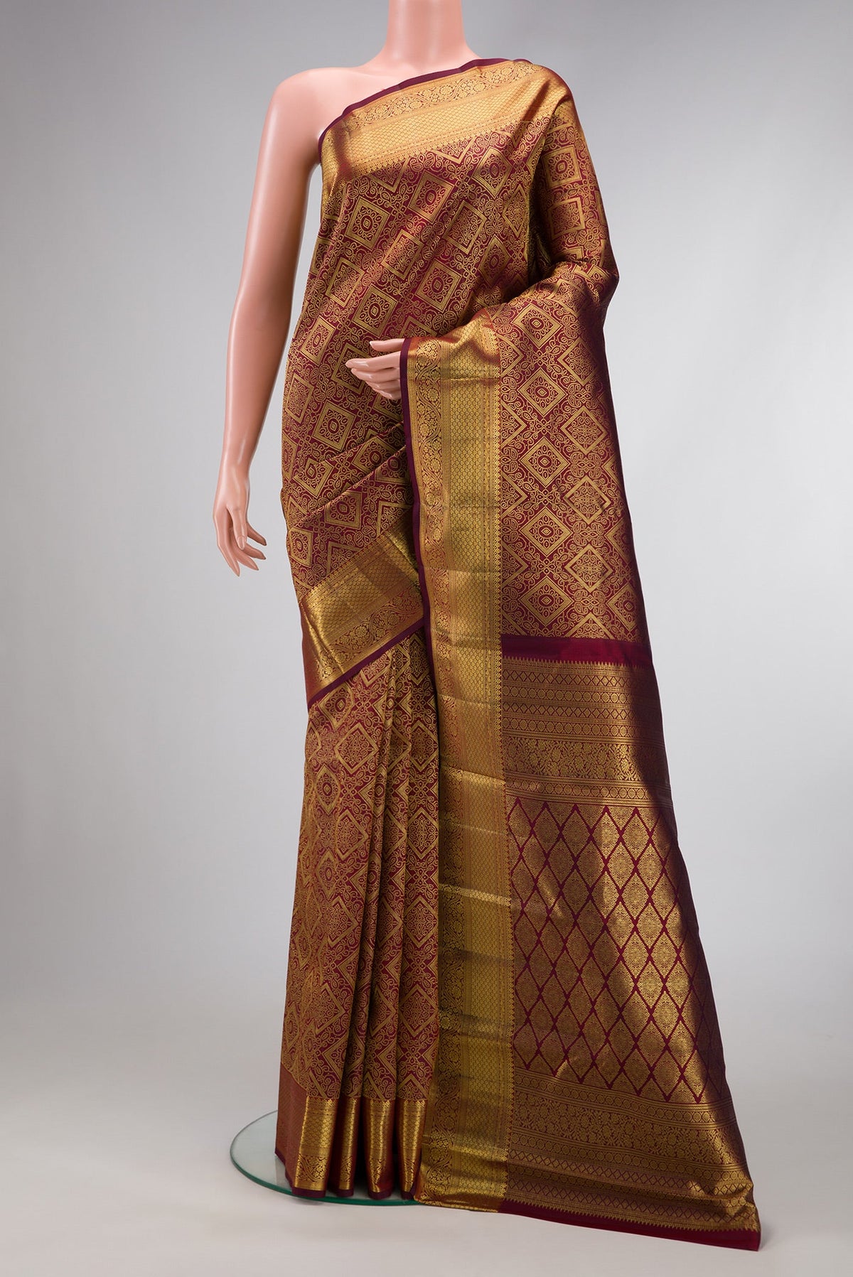 Maroon Dual Tone Kanchipuram Silk Saree with Zari Brocade on the body and Zari Border.  displayed on a mannequin