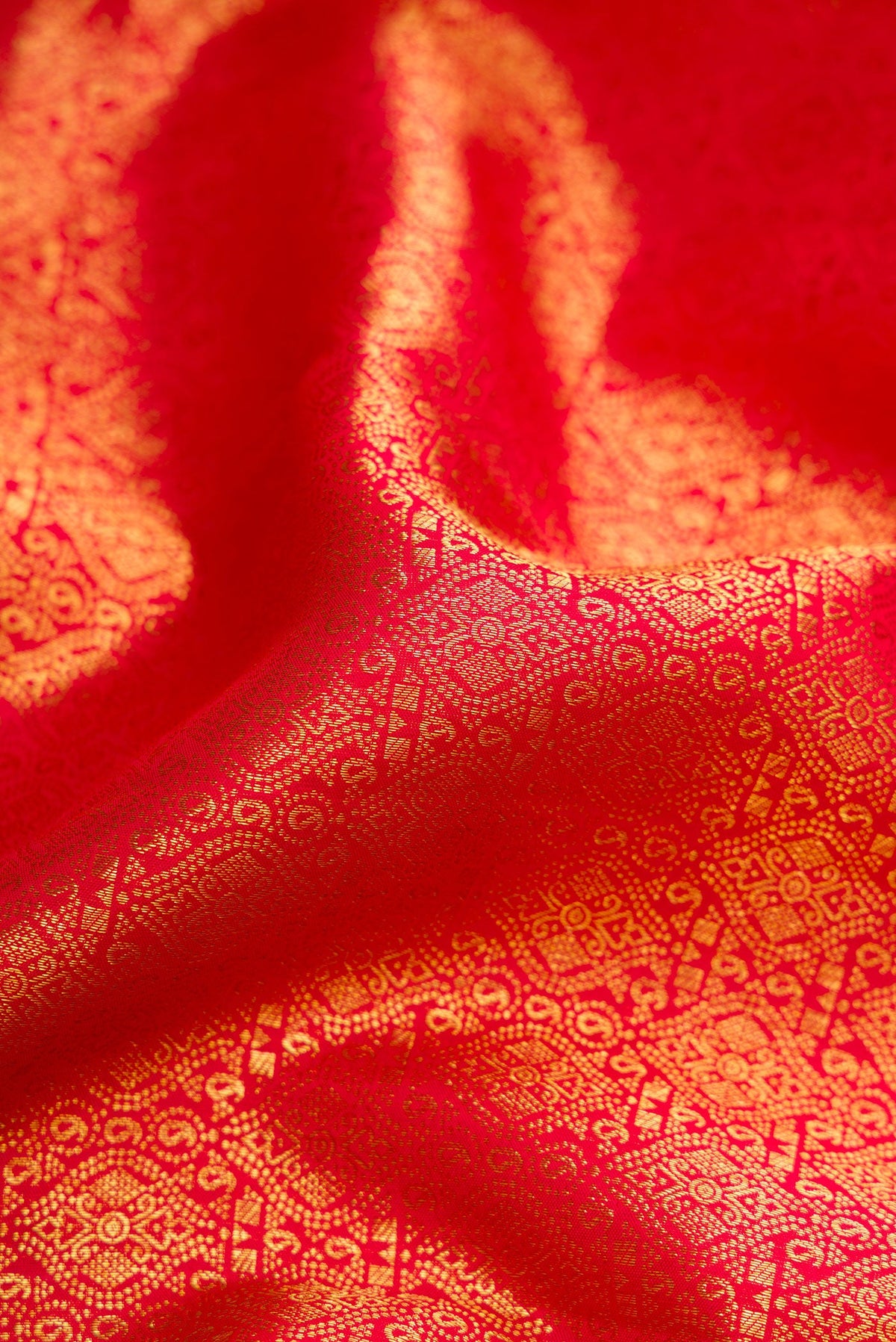 Close up of Red Dual Tone Kanchipuram Silk Saree with Zari Brocade on the body and Zari Border.  displaying folds