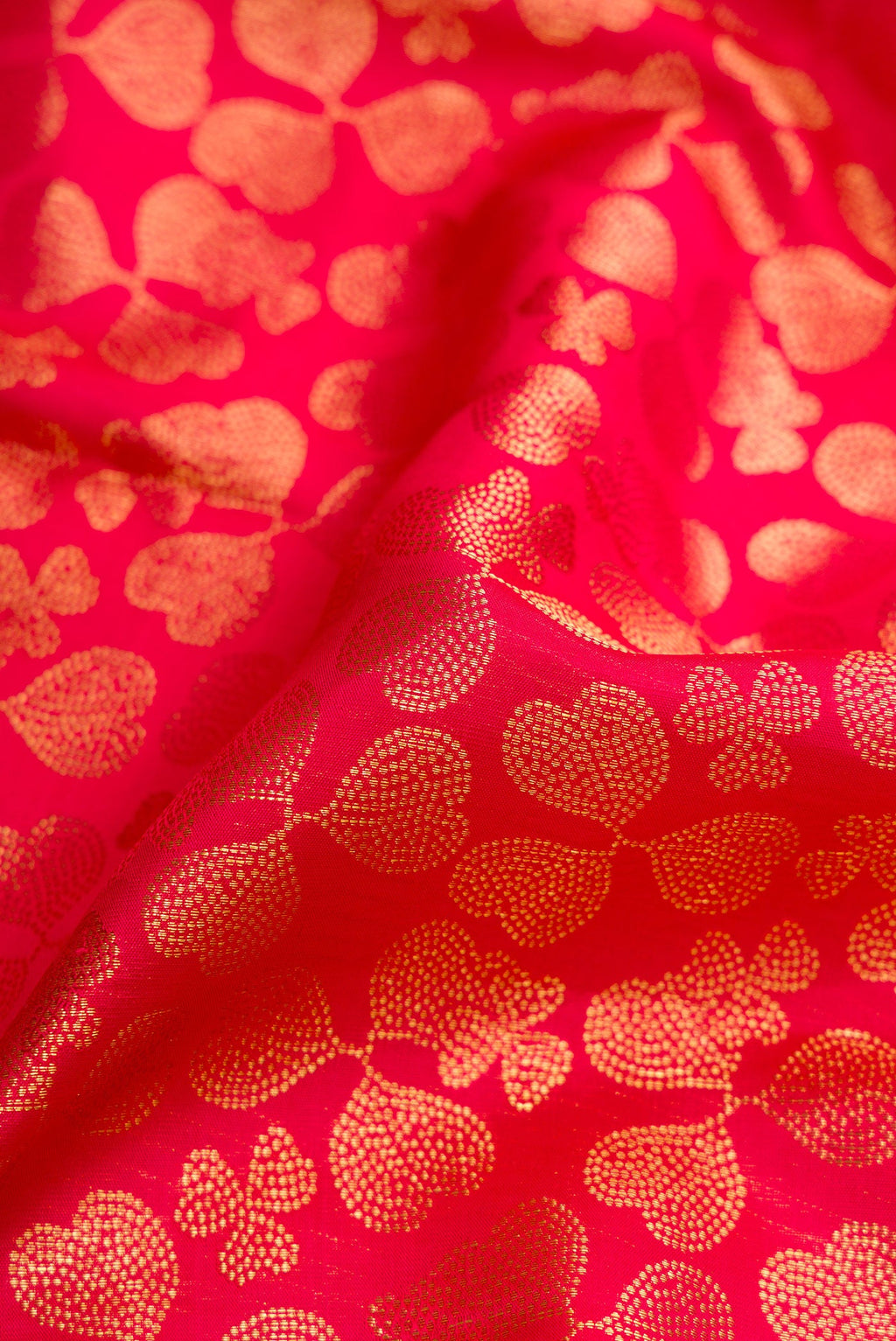 Close up of Dark Pink Dual Tone Kanchipuram Silk Saree with Zari Brocade on the body and Zari Border.  displaying folds