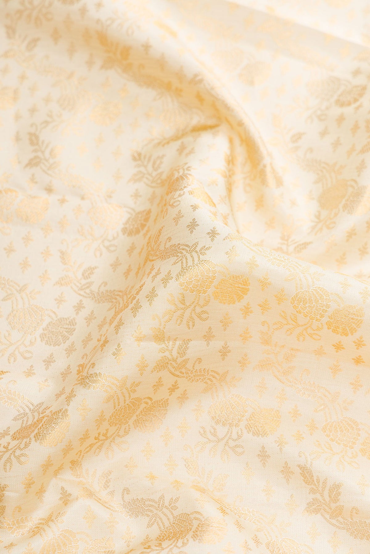 Close up of Off White Dual Tone Kanjivaram Silk Saree with Zari Brocade on the body and Zari Border.  displaying folds