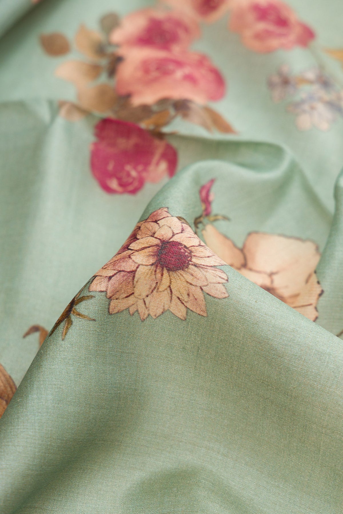 Close up of Sea Green Dual Tone Tussar Silk Saree with Printed design on the body and Zari Border.  displaying folds