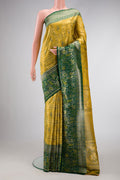 Gold Dual Tone Kanjivaram Tissue Silk Saree with Zari Brocade on the body and Zari Border.  displayed on a mannequin