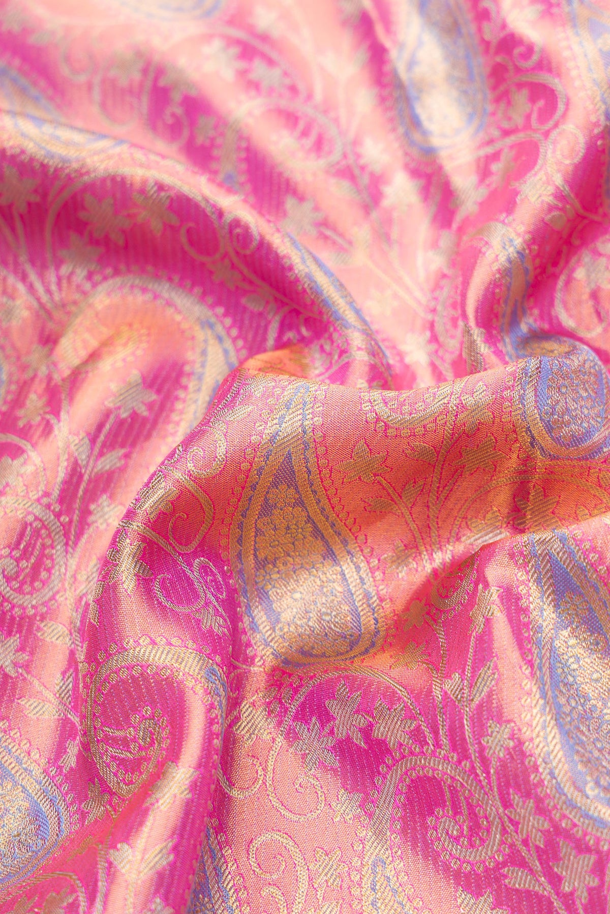 Close up of Pink Dual Tone Kanjivaram Tissue Silk Saree with Zari Brocade on the body and Zari Border.  displaying folds