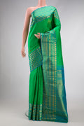 Green Dual Tone Kanchipuram Silk Saree with Zari Butta on the body and Zari Border.  displayed on a mannequin
