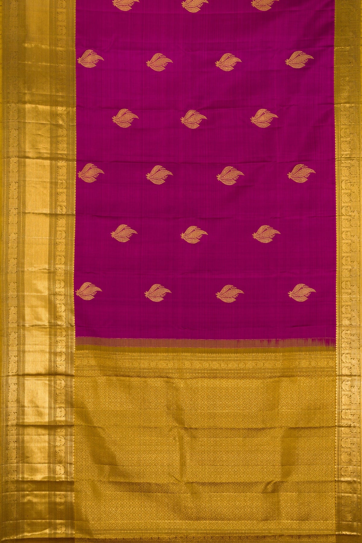 Flat view of Magenta Kanchipuram Silk Saree with Zari Butta on the body and Zari Border. 