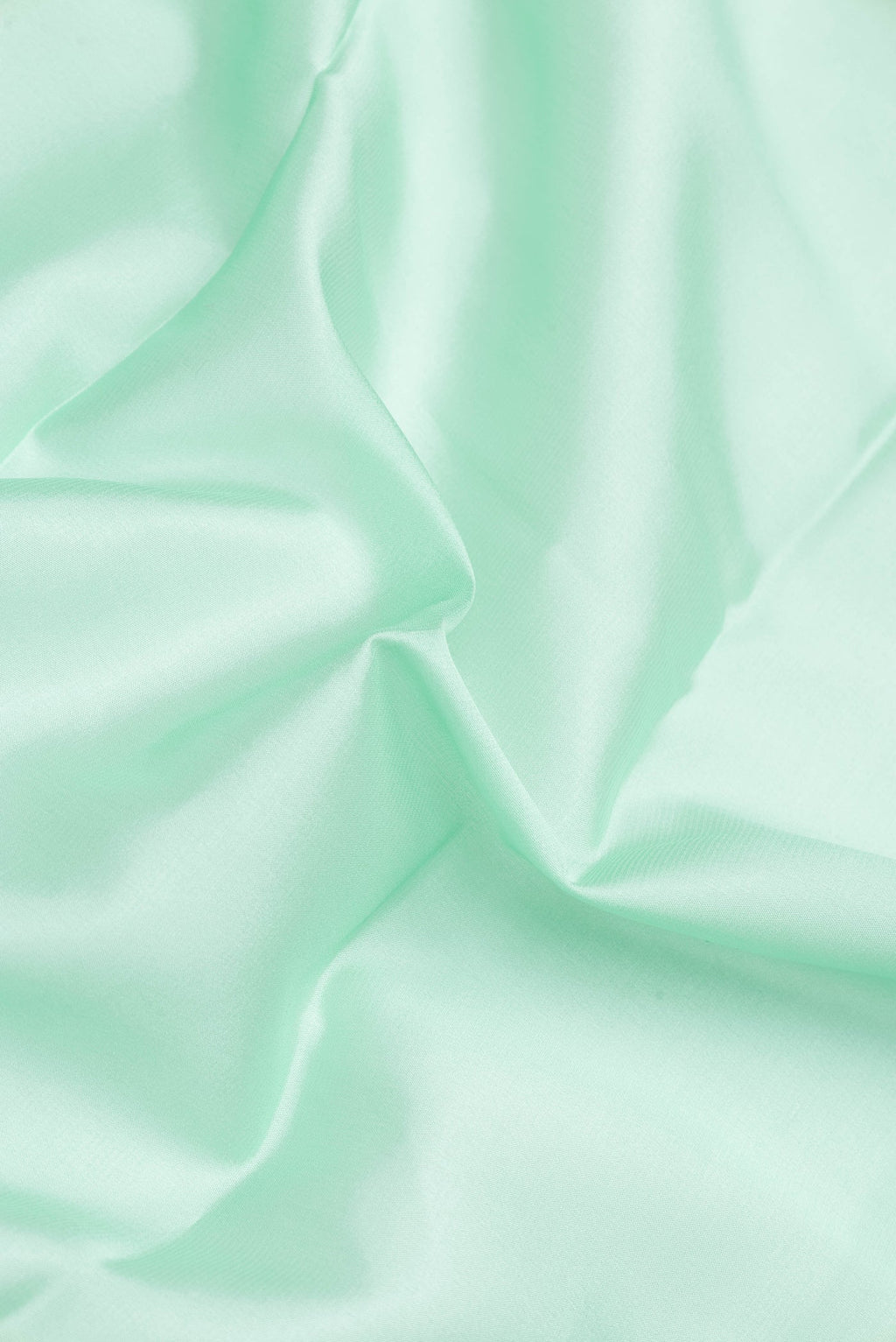 Close up of Pista Green Dual Tone Mysore Silk Saree with Plain Body and Zari Border.  displaying folds