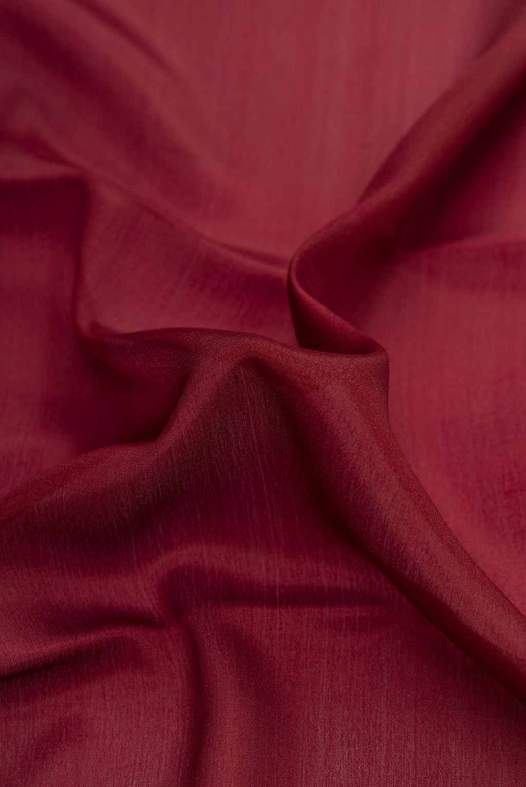 Close up of Brown Dual Tone Mysore Crepe Saree with Plain Body and Zari Border.  displaying folds