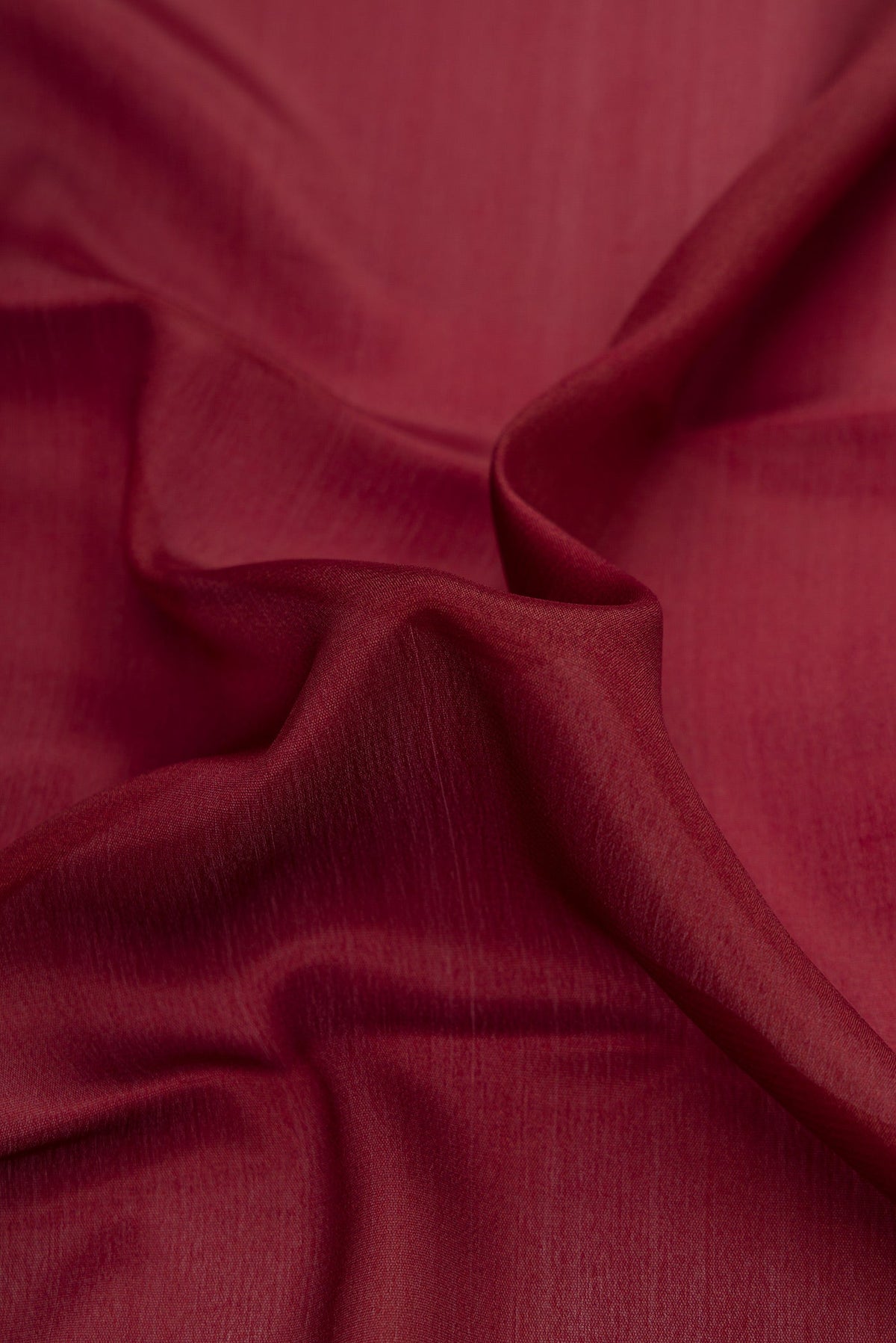 Close up of Brown Dual Tone Mysore Crepe Saree with Plain Body and Zari Border.  displaying folds