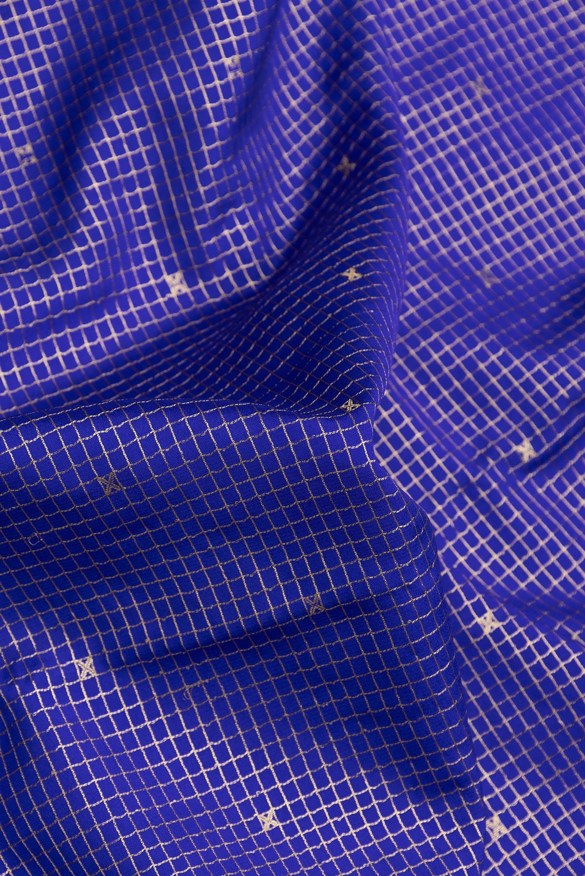 Close up of Royal Blue Dual Tone Mysore Silk Saree with Checked design on the body and Zari Border.  displaying folds