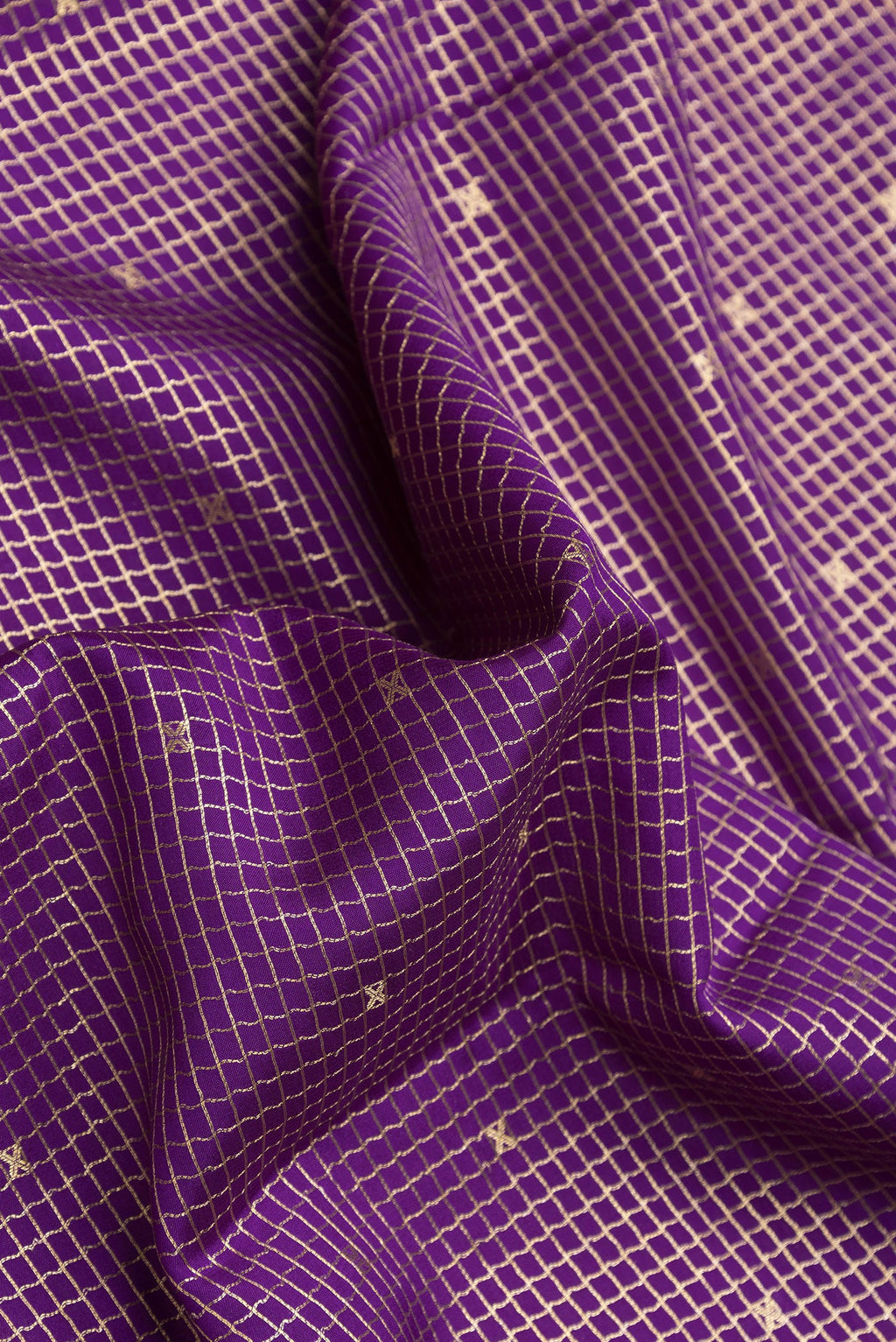 Close up of Violet Dual Tone Mysore Silk Saree with Checked design on the body and Zari Border.  displaying folds